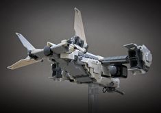 a lego model of a fighter jet with propellers on it's back legs and wings