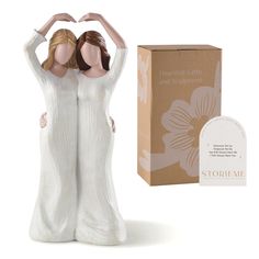 a ceramic figurine that is next to a box