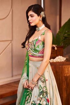 Mint green lehenga featuring flora and fauna motifs embroidered with sequins, crystals, mirror, cutdana, and tassels. Paired with a coordinating lace embroidered padded blouse and a tasselled dupatta., Fit: Relaxed Green Set With Floral Embroidery And Traditional Drape, Reception Green Sharara With Floral Embroidery, Green Lehenga With Floral Embroidery For Diwali, Green Floral Embroidered Lehenga For Diwali, Green Sharara With Floral Embroidery For Navratri, Green Lehenga With Floral Embroidery For Navratri, Green Floral Embroidered Sharara For Navratri, Fitted Green Lehenga With Floral Embroidery, Sleeveless Green Anarkali Set With Dupatta