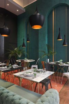 an empty restaurant with green walls and chairs