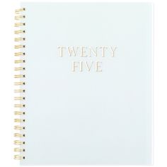 a white spiral notebook with the words twenty five written in gold foil on top of it