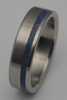 a wedding ring with blue and silver inlays