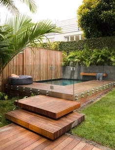 a wooden deck in the middle of a yard