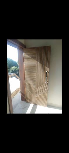 an open door in the corner of a room with sunlight coming through it and outside