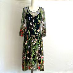 This Beautiful Sheer, Embroidered Floral Dress Comes With A Black Cotton Jersey Slip. The Dress Fabric Is Polyester With Machine-Crafted Embroidery. Elegant And Breezy, This Dress Is Ideal For A Cocktail Party, Wedding, Convention, Fancy Dinner, And More. It Also Can Be Used As A Beach Cover-Up! 3/4’’ Bell Sleeve. Style # - K4925 - W498 Pet And Smoke-Free. Measurements: Armpit To Armpit - 17’’ Front Length - 44’’, Back Length - 49’’ Arm Length - 19’’ (Shoulder Seam To Cuff) Spring Multicolor Embellished Embroidered Dress, Spring Embellished Embroidered Dress For Garden Party, Fitted Green Midi Dress With Floral Embroidery, Fitted Spring Embroidered Dress With Embroidered Hem, Spring Bohemian Embroidered Evening Dress, Spring Evening Bohemian Embroidered Dress, Black Dresses With Intricate Embroidery For Spring, Black Dress With Intricate Embroidery For Spring, Green Embroidered Dress For Spring