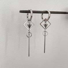 Introducing our effortlessly chic geometric dangling earrings in stainless steel - a must-have addition to your jewelry collection! These trendy unisex earrings are perfect for both men and women, adding a modern touch to any outfit. The sleek, minimalist design makes them versatile for any occasion, whether you're dressing up for a night out or adding a subtle statement to your everyday look. Elevate your style with these geometric earrings that are sure to turn heads and make you stand out fro Casual Stainless Steel Dangle Hoop Earrings, Modern Metal Cartilage Earrings, Minimalist Stainless Steel Earrings For Gift, Modern Tarnish Resistant Dangle Hoop Earrings, Everyday Stainless Steel Dangle Hoop Earrings, Modern Hypoallergenic Dangle Cartilage Earrings, Minimalist Metal Plug Earrings As Gift, Tarnish Resistant Metal Dangle Cartilage Earrings, Minimalist Single Earring In Surgical Steel