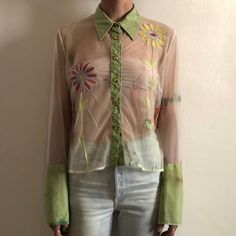 Cool 1990s Romeo Gigli sheer nylon mesh blouse with embroidered flowers. Great 90s pop style - looks like something to be worn in a Dee Lite video. Irregularily dyed nylon mesh in a light green and white. Super sheer. Bright shiny embroidered flowers decorate the front and the back. The buttons! are square shaped yellow jewels. Four buttons on each wide sleeve cuff. Label Gigli, made in Italy, size XL. 100% nylon. Please wash by hand cool, drip dry. Very good vintage condition with no fabric or Sheer Button Up Blouse Outfit, Mesh Button Up, Romeo Gigli, Mesh Blouse, Mesh Shirt, Pop Style, Green Tie, Sleeve Cuff, Drip Dry