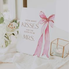 a card that says how many kisses for the son - to - be mrs on it