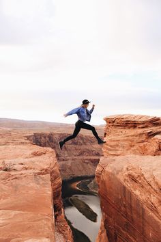 a man jumping into the air over a canyon