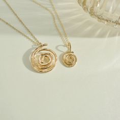 Embrace the essence of growth and evolution with our handcrafted gold-filled Mini Spiral pendant necklace. This elegant piece symbolizes continuous development and life's journey, capturing the beauty of expansion and progress in its timeless design. Perfect for those who appreciate meaningful and exquisite jewelry. Handcrafted in the USA. DETAILS: Material: 14/20 gold-filled, Skin Friendly Dimensions: Pendant 10mm Chain Length 18" plus 2" extender chain Note: As each piece is handcrafted dimensions and shapes can slightly vary ensuring no two are exactly alike. 14k Gold Spiral Jewelry For Anniversary, Spiral Rose Gold Jewelry For Anniversary, Spiral Rose Gold Jewelry Gift, Modern Twist Recycled Gold Jewelry Gift, Modern Twist Recycled Gold Jewelry For Gift, Minimalist Spiral Jewelry For Anniversary, Spiral Gold-plated Jewelry, Swirl Shaped Sterling Silver Jewelry In Gold Color, Minimalist 14k Gold Spiral Jewelry