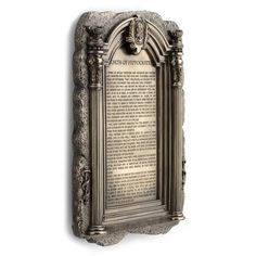 a stone plaque with an ornate frame and scroll on the bottom, in front of a white background