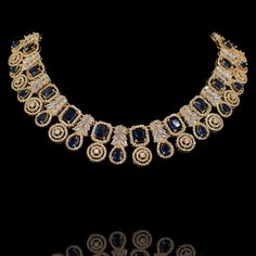 This wear-with-all piece is just perfect for those who love their statement accessories with mixed media flair! Timeless and modern, this hand crafted set dazzle with an elegant frame traced with CZ and sapphire stones. The set includes a necklace and a pair of matching earrings. Approximate earrings length is 1.5". Gold-plated on high-quality brass as base metal. Made by order. Kindly allow 5-7 weeks for the delivery of this item. For custom or urgent requests, please contact support@alacouture Luxury Sapphire Necklace For Party, Fine Jewelry Sapphire Necklaces For Party, Fine Sapphire Necklaces For Party, Fine Jewelry Sapphire Necklace For Party, Elegant Crystal Jewelry With Gemstone Accents, Fine Sapphire Necklace For Party, Exquisite Evening Jewelry With Gemstone Accents, Elegant Sapphire Necklace With Hand-set Details, Party Sapphire Necklace With Sparkling Stones