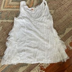 Lilka Brand Tee Purchased From Anthropologie Online Never Worn This Was Given To Me As A Gift. This Is An Oversized Tank Size Small Very Cute Lace Inserts On Sides. Would Be Cute For A Bride To Be Or On A Honeymoon Or Any Occasion. Cotton Ruffle Tank Top, Spring Tops With Lace Trim For Layering, Stretch Tank Top With Ruffles, White Scoop Neck Top For Spring, Casual Tops With Lace Trim For Layering, Casual Lace Trim Tops For Layering, Summer Cotton Top With Lace Trim, Casual Ruffled Tank Top, Casual Ruffle Tank Top