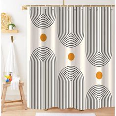 a bathroom with a shower curtain that has circles and dots on it, along with a rug