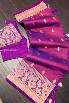 An exquisite Wwine color Handloom Pure Katan Silk Banarasi Saree. This saree is Silk Mark Certified. The saree features zari weaved motifs throughout the body. The border and pallu are a deep purple color and have intricate traditional banarasi zari weaving. Pico and fall done and saree ready to wear. Blouse stitched - Yes Blouse Opening - Front Sleeves Length - Elbow Padded - No Blouse size - 38, expandable upto 40/42 NO RETURNS on sarees with stitched blouses.  They are tailored to standard si Unstitched Traditional Purple Blouse Piece, Unstitched Purple Traditional Blouse Piece, Traditional Purple Tussar Silk Blouse Piece, Festive Purple Banarasi Silk Anarkali Set, Traditional Purple Banarasi Silk Blouse Piece, Purple Katan Silk Dupatta With Unstitched Blouse, Purple Blouse Piece With Zari Work For Puja, Purple Banarasi Silk Anarkali Set, Purple Banarasi Silk Anarkali Set With Dupatta