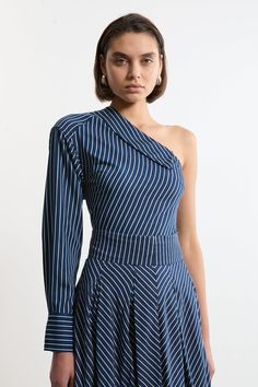 Elevate Your Wardrobe Essentials In Our Shirt, Which Features An Asymmetric Design That Is Certain To Turn Heads. With A Collar Style Neckline, Sitting At A One Shoulder Angle, And A Pinstripe Pattern, This Piece Styles Well With Jeans Or Tailored Trousers For An Outfit That Can Be Worn Again And Again. Asymmetric Twill Striped Woven Long Sleeved Shirt High Quality Twill Fabric Flattering Relaxed Fit Unique One Shoulder, Asymmetric Design Classic Pinstripe Print Matching Skirt Sold Separately Petite Work Outfits, Petite Wedding Guest Dresses, Plus Size Workwear, Figure Dress, Pinstripe Pattern, Summer 2025, Outfits Petite, Petite Coat, Plus Size Coats