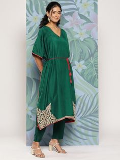 Green embroidered Kurta with TrousersKurta design:Solid with placement embroideryKaftan shapeRegular styleV-neck, three-quarter extended sleevesZari detailCalf length length with flared hemCotton blend machine weave fabricComes with a fabric beltTrousers design:Solid TrousersPartially elasticated waistbandSlip-on closure Floor-length Semi-stitched Resham Embroidery Kurta, Green Embroidered Straight Kurta Tunic, Semi-stitched Embroidered Green Kurta, Embroidered Yoke Kurta, Green Embroidered V-neck Kaftan, Fabric Belt, Kurta Designs, Thread Work, Yellow Floral