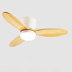 a white ceiling fan with wooden blades on it's blade and two light bulbs