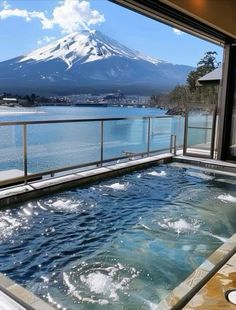 an indoor hot tub with a view of the mountain fuji in the background, taken from inside a house