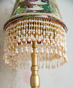 a lamp with beads hanging from it's side