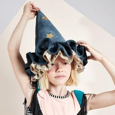 This witch's/wizard's hat, with ruffle details, is very stylish indeed. It is crafted from blue velvet, with gold lamé and gold glitter stars and moons. An essential accessory for Halloween, or to add to a dressing up box for imaginative play any time of the year. The hat is made from soft blue velvet It has ruffle details on the brim made from blue velvet and shiny gold lamé It has a blue velvet elastic strap with a hook and loop fastener Gold glitter stars and moons add a delightful embellishm Gold Glitter Stars, Stars And Moons, 일본 패션, Authentic Models, Ren Fest, Meri Meri, Glitter Stars, Blue Hat, Fantasy Clothing