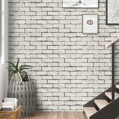 a white brick wall with stairs leading up to it and a plant in the corner