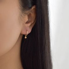 Sweet and dainty, these gold huggie earrings feature a polished round charm. Made of 14K gold filled materials, these earrings are tarnish-resistant, water-resistant, and hypoallergenic. Hoop measures 12mm in diameter while the charm measures 4mm in diameter. To put them on, don't pull the hoop apart, instead bend them towards opposite sides like shown in the photo. --------------------♥ PROMOS ♥-------------------- Want 10% off? Join the mailing list by visiting http://bit.ly/vedern . Just leav Minimalist Small Hoop Earrings For Gift, Teardrop Cartilage Earring As Gift, Delicate Small Hoop Earrings With Ear Wire, Delicate Dangle Huggie Earrings As Gift, Single Dangle Hoop Earring As A Gift, Everyday Dangle Hoop Earrings, Everyday Handmade Huggie Earrings, Dainty Small Hoop Wrap Earrings As Gift, Everyday Dangle Hoop Earrings For Pierced Ears