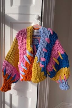 colorful knitted sweater hanging on the door