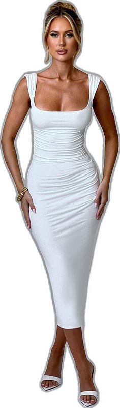 a woman in a white dress with her hands on her hips