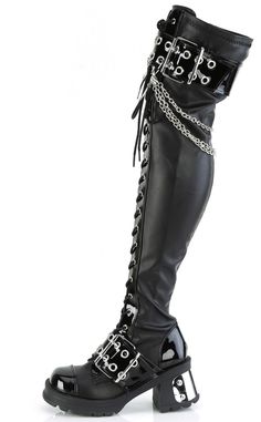 Show a li'l attitude! The BRATTY-304 thigh high boots are made with comfortable stretch faux leather, decked out in punk deets like patent straps, buckles, chains and an oversized horseshoe ring charm. Slip in n' out with a full length side zip and lace-up front. The Bratty series features a 2 3/4" (70mm) heel and a 1" (25mm) platform. Material: 100% vegan PU. U.S women's sizing - refer to size chart for more info