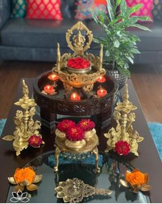 a coffee table with candles and flowers on it