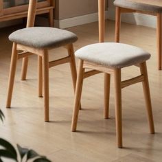 two wooden chairs sitting on top of a hard wood floor