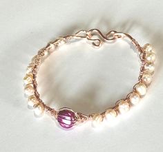 Soft pink freshwater pearl wire wrapped bangle Wire Wrapped Pearl Bracelet, Rose Gold Pearl Jewelry With Wire Wrapped Detail, Adjustable Handmade Rose Gold Pearl Bracelet, Elegant Pink Wire Wrapped Bracelets, Elegant Copper Wire Bangle Bracelets, Handmade Rose Gold Pearl Bracelet, Rose Gold Wire-wrapped Copper Bracelets, Wire Wrapped Pearl, Wire Wrapped Bangles