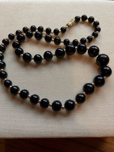 Vintage black graduated beaded necklace with screw barrel clasp small gold colour beads In between 18 inches long Classic Formal Necklaces With Large Beads, Classic Formal Necklace With Large Beads, Classic Black Beaded Necklaces With Polished Beads, Formal Black Beaded Necklace, Classic Black Beaded Necklace With Polished Beads, Classic Black Beaded Necklaces, Formal Beaded Necklaces With Large Round Beads, Formal Beaded Necklaces With Large Beads, Black Beaded Necklaces For Formal Occasions