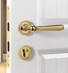 a white door with gold handles and knobs