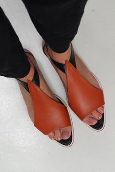 Delicate leather sandals in orange, pink and black colour-block with an elasticated side buckle fastening and leather soles. Unsure about your size? Please refer to our sizing page or send us a message using the chat button on our website. We will answer straight away. Coral Sandals, Buckled Flats, Leather Sandals Flat, Pearl Jewellery Earrings, Cleaning Clothes, Leather Sandals, Shoes Flats, Designer Shoes, Pink Ladies