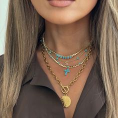 This turquoise bead necklace features a delicate cross charm, blending faith with vibrant style. From our Eternal Skies collection, it’s a meaningful piece perfect for layering or wearing solo. A timeless symbol, this necklace makes a thoughtful gift for any occasion. Material: 14K Gold Plated BrassStones: Turquoise ResinStone Size: 3.5mmLength: Adjustable up to 12" - 16" Turquoise Cross Necklace, Turquoise Resin, Turquoise Necklaces, Timeless Symbol, Turquoise Cross, Stacked Necklaces, Turquoise Bead Necklaces, Vibrant Style, Stacked Jewelry