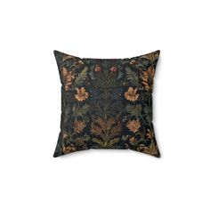 a black and gold pillow with flowers on it