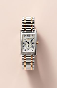 Launched in 1997, the DolceVita collection expresses a contemporary interpretation of watchmaking elegance. The slim rectangular case, a silver flinqué dial, blue steel hands and painted Roman numerals create a refined, feminine aesthetic. Style Name:Longines Dolcevita Bracelet Watch, 20.5mm X 32mm. Style Number: 5462325. Available in stores. Roman Numeral Wrist Watch, Elegant Silver Watch With Square Face, Elegant Rectangular Watch Accessories With Date Display, White Gold Watch Accessories With Rectangular Metal Dial, Elegant Watches Women, Rectangle Watch, Gold And Silver Watch, Womens Designer Watches, Silver Watches Women