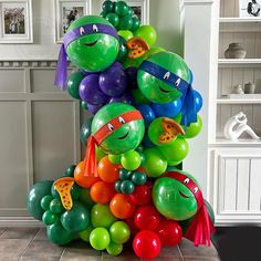 a bunch of balloons in the shape of teenage mutants are stacked on top of each other