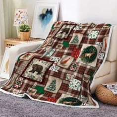 there is a blanket on the bed with animals and christmas trees in plaid pattern, along with other items