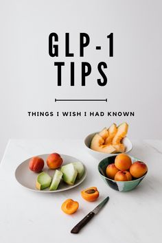 two bowls filled with fruit sitting on top of a white counter next to a knife