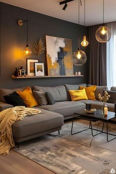 a living room with grey couches and yellow pillows