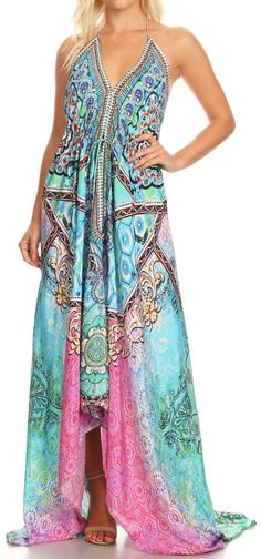 One size regular: Bust 38" (96.5 cm), Length 47" (119 cm). US 0-10, EU 30-40, UK 4-14. Shell: Silky polyester with colorful digital print. Care: Wash cold, iron from the reverse, hang dry. Dry clean recommended. Striking and dazzling maxi halter dress with embellishment and precious rock like tassels. Silky texture and light as a feather. This lovely dress features a built-in waist and shoulder tie, perfect to accommodate it to your body type. It also features a handkerchief hem and lots of volu