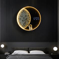 a bedroom with a bed, night stand and clock on the wall next to it