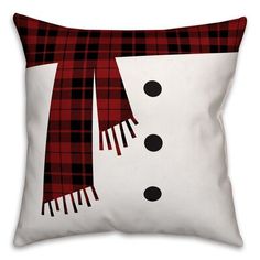 a snowman pillow with a red and black plaid scarf on it's head