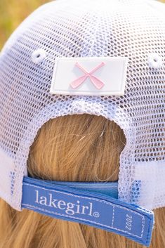 the back of a woman's head wearing a lakegirl hat