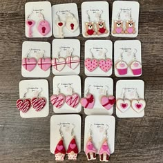 twelve valentine's day earrings are arranged in rows on white cards with pink and red accents