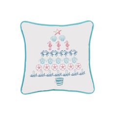 a pillow with a christmas tree on it and seashells in the shape of a star