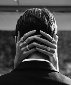 a man with his hands on his face in front of him, covering his eyes